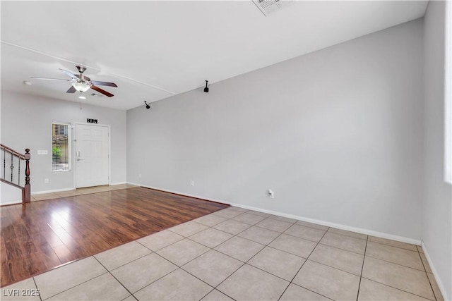 6678 Crystal Run Ln, Las Vegas, NV 89122 - unfurnished room with light tile patterned flooring, a ceiling fan, and stairs