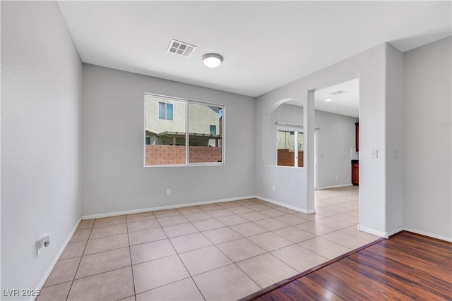 6678 Crystal Run Ln, Las Vegas, NV 89122 - empty room with arched walkways and light wood finished floors