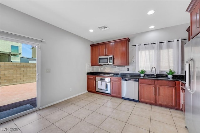 6678 Crystal Run Ln, Las Vegas, NV 89122 - kitchen featuring appliances with stainless steel finishes, backsplash, light tile patterned floors, reddish brown cabinets, and recessed lighting