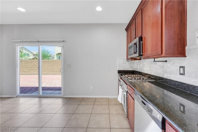 6678 Crystal Run Ln, Las Vegas, NV 89122 - kitchen featuring stainless steel appliances, dark stone countertops, backsplash, recessed lighting, and light tile patterned flooring