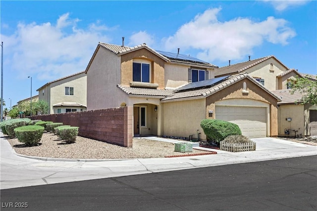 6678 Crystal Run Ln, Las Vegas, NV 89122 - view of front of property featuring solar panels, stucco siding, an attached garage, a tile roof, and driveway