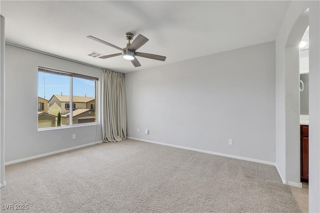 6678 Crystal Run Ln, Las Vegas, NV 89122 - spare room featuring a ceiling fan, light colored carpet, and arched walkways