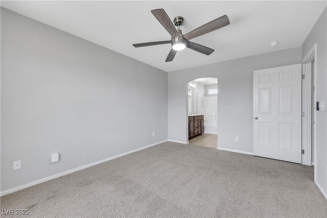 6678 Crystal Run Ln, Las Vegas, NV 89122 - unfurnished bedroom with arched walkways, carpet floors, ensuite bathroom, and ceiling fan