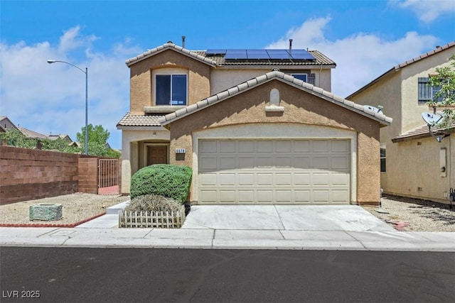 6678 Crystal Run Ln, Las Vegas, NV 89122 - mediterranean / spanish home with a tiled roof, roof mounted solar panels, driveway, an attached garage, and stucco siding