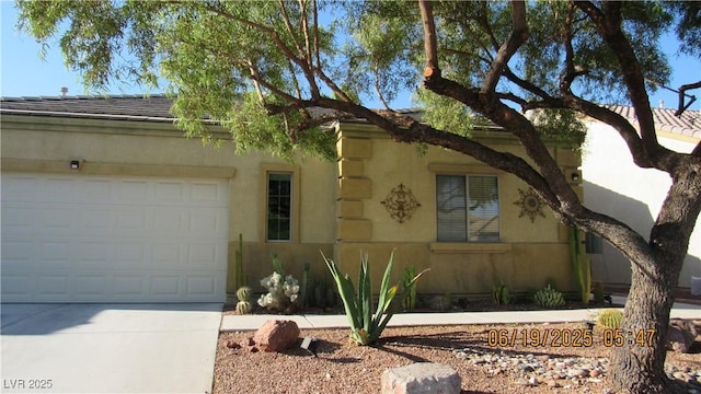 1504 Andrew David Ave, North Las Vegas, NV 89086 - view of front of home with a garage, driveway, and stucco siding