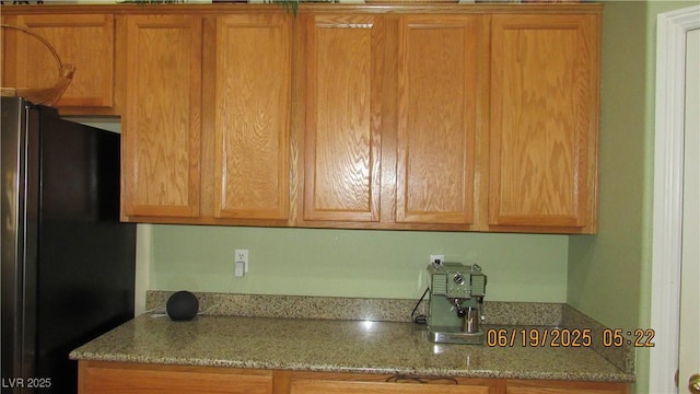 1504 Andrew David Ave, North Las Vegas, NV 89086 - kitchen featuring freestanding refrigerator and light stone counters