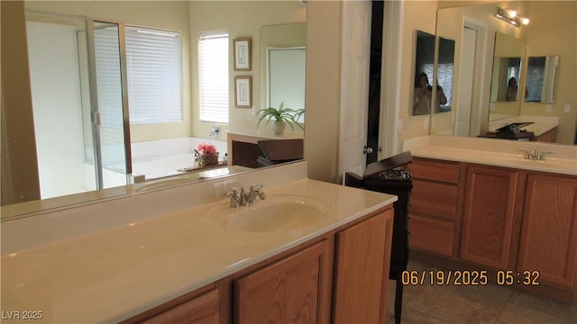 1504 Andrew David Ave, North Las Vegas, NV 89086 - bathroom featuring two vanities, a bath, and tile patterned floors