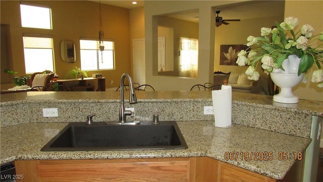 1504 Andrew David Ave, North Las Vegas, NV 89086 - kitchen with light stone countertops, a ceiling fan, and dishwasher