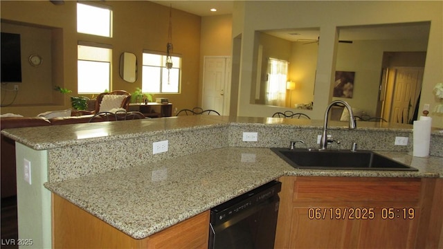 1504 Andrew David Ave, North Las Vegas, NV 89086 - kitchen featuring dishwasher, open floor plan, light stone countertops, ceiling fan, and brown cabinets