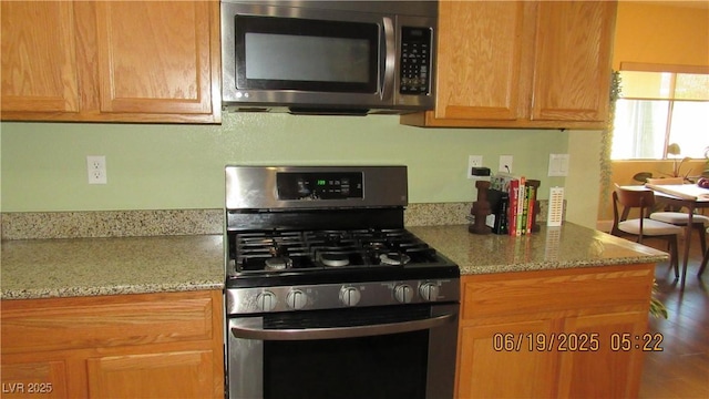 1504 Andrew David Ave, North Las Vegas, NV 89086 - kitchen featuring appliances with stainless steel finishes and light stone countertops