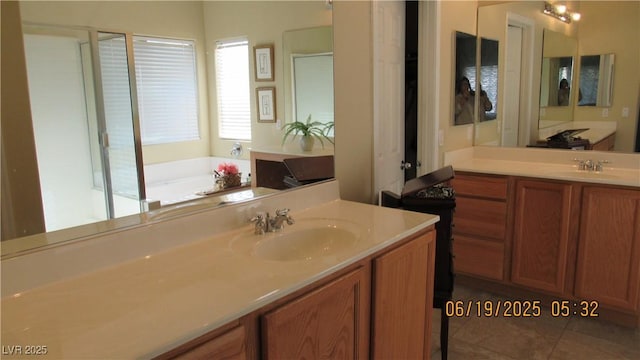 1504 Andrew David Ave, North Las Vegas, NV 89086 - bathroom featuring two vanities, a garden tub, and tile patterned flooring