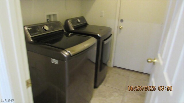 1504 Andrew David Ave, North Las Vegas, NV 89086 - laundry area with separate washer and dryer and light tile patterned floors