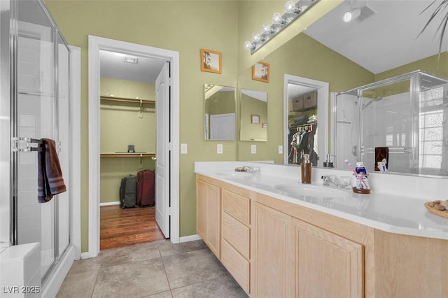 9909 Masked Duck Ave, Las Vegas, NV 89117 - bathroom with a spacious closet, double vanity, a stall shower, and tile patterned floors