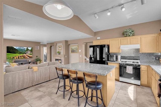 9909 Masked Duck Ave, Las Vegas, NV 89117 - kitchen with white range oven, black fridge, under cabinet range hood, light brown cabinets, and a center island