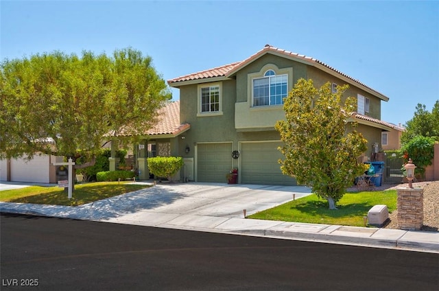 9909 Masked Duck Ave, Las Vegas, NV 89117 - view of front of home featuring a tile roof, an attached garage, concrete driveway, and stucco siding