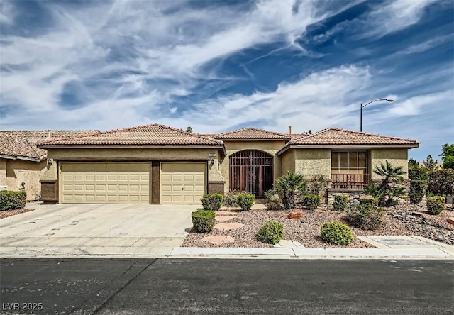 8698 Waterford Bend St, Las Vegas, NV 89123 - mediterranean / spanish-style home with an attached garage, driveway, and stucco siding