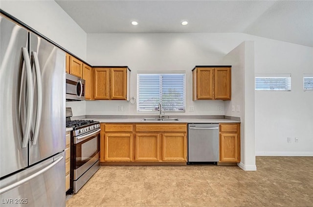 2059 Joy View Ln, Henderson, NV 89012 - kitchen featuring appliances with stainless steel finishes, light countertops, vaulted ceiling, brown cabinetry, and recessed lighting