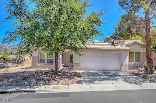 2059 Joy View Ln, Henderson, NV 89012 - view of front of home featuring a garage, stucco siding, driveway, and a tile roof