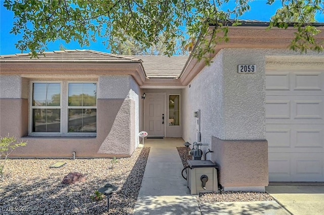 2059 Joy View Ln, Henderson, NV 89012 - property entrance featuring stucco siding, an attached garage, and a tile roof