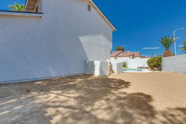 1926 Navarre Ln, Henderson, NV 89014 - view of side of home with a fenced backyard, stucco siding, and a patio area