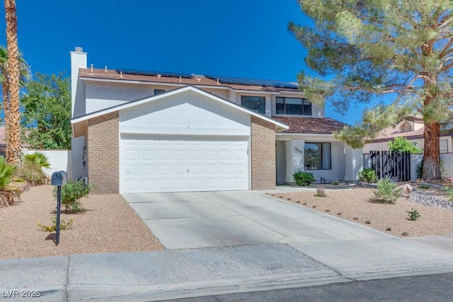 1926 Navarre Ln, Henderson, NV 89014 - traditional-style house featuring brick siding, an attached garage, concrete driveway, and solar panels
