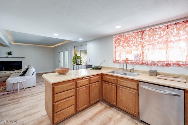 1926 Navarre Ln, Henderson, NV 89014 - kitchen featuring stainless steel dishwasher, light wood-style floors, light countertops, a peninsula, and recessed lighting