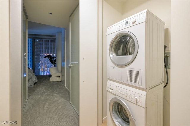 3722 Las Vegas Blvd Unit 2512E, Las Vegas, NV 89158 - laundry area featuring stacked washing machine and dryer and carpet flooring
