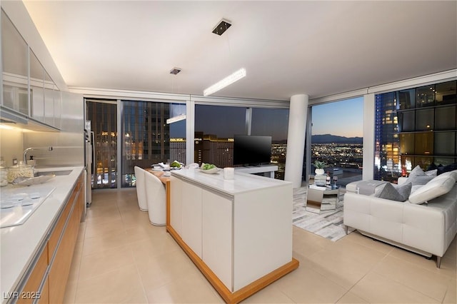 3722 Las Vegas Blvd Unit 2512E, Las Vegas, NV 89158 - kitchen with a wall of windows, light tile patterned floors, open floor plan, light countertops, and white cabinetry