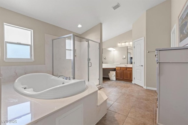 6958 Lazy Sunset Ct, Las Vegas, NV 89156 - bathroom with vanity, a stall shower, a tub with jets, tile patterned flooring, and vaulted ceiling