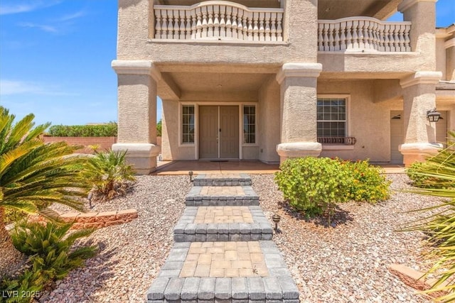 6958 Lazy Sunset Ct, Las Vegas, NV 89156 - doorway to property with a balcony and stucco siding