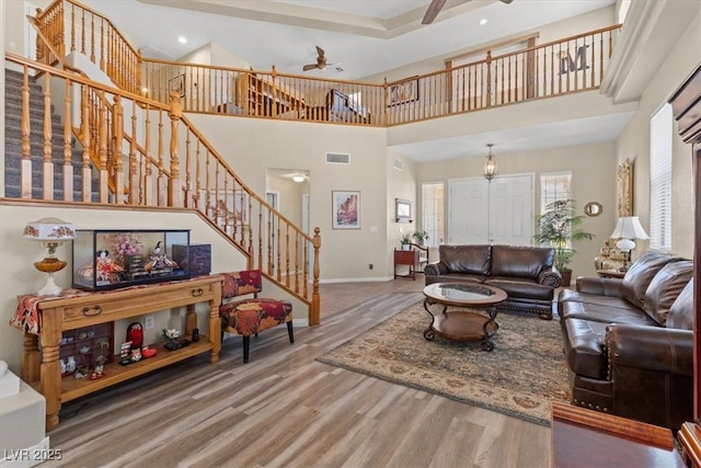 6958 Lazy Sunset Ct, Las Vegas, NV 89156 - living area featuring a ceiling fan, stairs, wood finished floors, a high ceiling, and recessed lighting