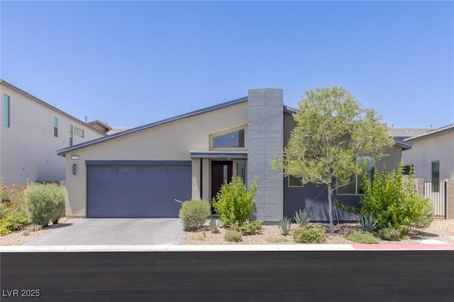 9785 Granite Mesa St, Las Vegas, NV 89141 - view of front facade with stucco siding, an attached garage, and driveway