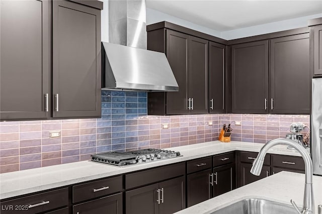 9785 Granite Mesa St, Las Vegas, NV 89141 - kitchen with wall chimney exhaust hood, stainless steel gas cooktop, light stone countertops, and backsplash