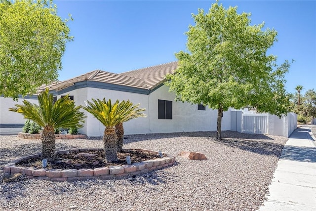 9100 Shelter Cove Ct, Las Vegas, NV 89117 - view of front of house with a tiled roof and stucco siding