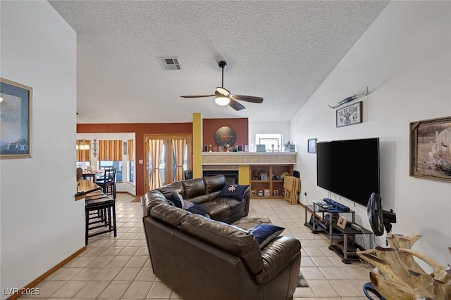 9100 Shelter Cove Ct, Las Vegas, NV 89117 - living area with ceiling fan, a textured ceiling, healthy amount of natural light, light tile patterned floors, and vaulted ceiling