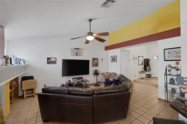 9100 Shelter Cove Ct, Las Vegas, NV 89117 - living room featuring light tile patterned floors, a textured ceiling, ceiling fan, lofted ceiling, and a fireplace