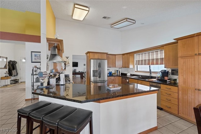 9100 Shelter Cove Ct, Las Vegas, NV 89117 - kitchen featuring appliances with stainless steel finishes, high vaulted ceiling, light tile patterned floors, a breakfast bar, and dark stone counters