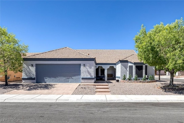 9100 Shelter Cove Ct, Las Vegas, NV 89117 - view of front of house with a garage, concrete driveway, stucco siding, and a tiled roof