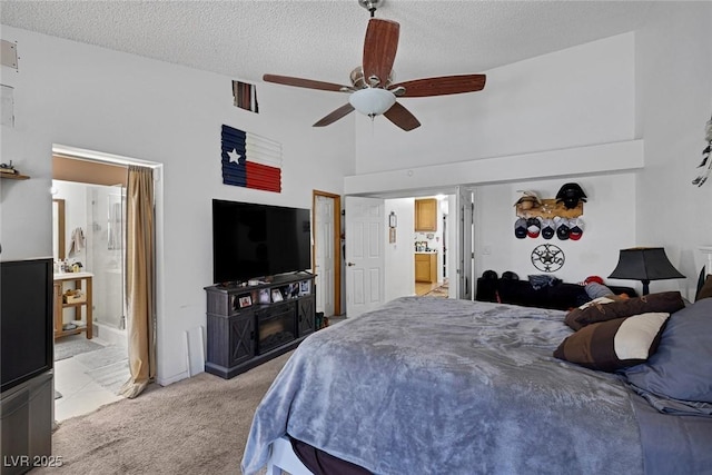 9100 Shelter Cove Ct, Las Vegas, NV 89117 - bedroom with light carpet, connected bathroom, a textured ceiling, a ceiling fan, and high vaulted ceiling