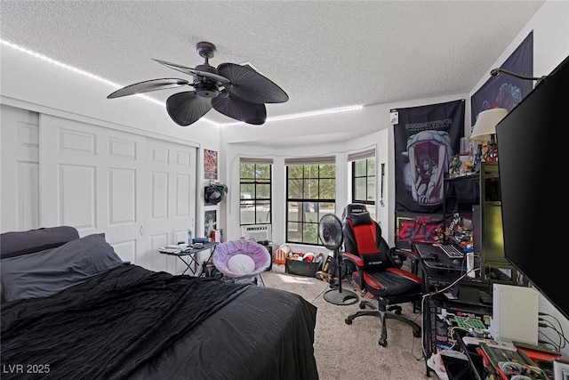 9100 Shelter Cove Ct, Las Vegas, NV 89117 - bedroom with carpet floors, a closet, ceiling fan, and a textured ceiling