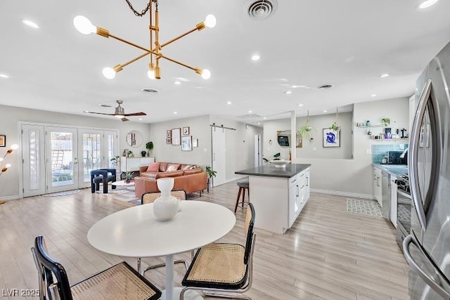 105 Shadow Ln, Las Vegas, NV 89106 - dining area with a chandelier, light wood-style flooring, french doors, and recessed lighting