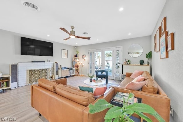 105 Shadow Ln, Las Vegas, NV 89106 - living area with ceiling fan, light wood finished floors, french doors, a fireplace, and recessed lighting