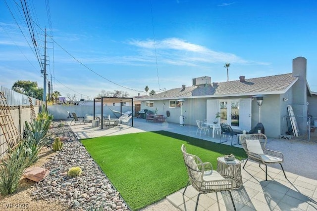 105 Shadow Ln, Las Vegas, NV 89106 - rear view of house featuring a fenced backyard, stucco siding, a patio, and a shingled roof
