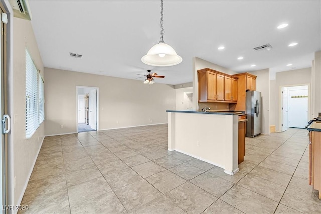 3720 Tack St, Las Vegas, NV 89122 - kitchen featuring stainless steel refrigerator with ice dispenser, dark countertops, a ceiling fan, decorative light fixtures, and light tile patterned floors