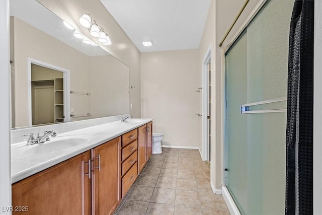 3720 Tack St, Las Vegas, NV 89122 - full bath featuring a stall shower, double vanity, tile patterned flooring, and a spacious closet
