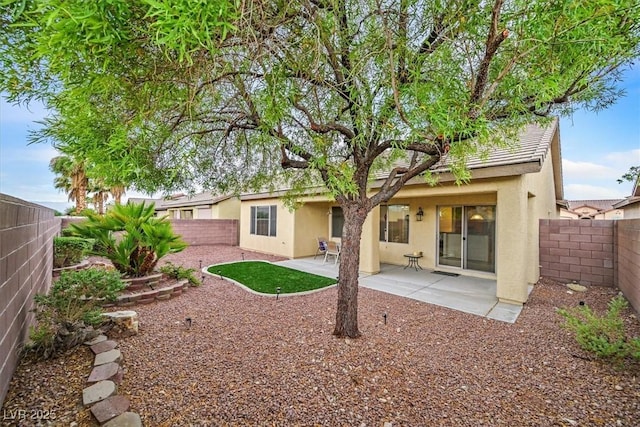 3720 Tack St, Las Vegas, NV 89122 - rear view of house featuring stucco siding, a fenced backyard, and a patio area