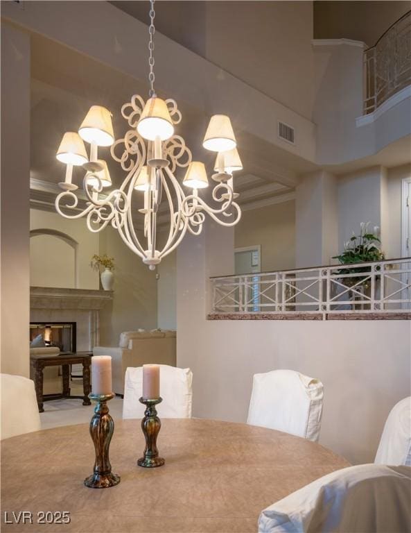 2041 Troon Dr, Henderson, NV 89074 - dining room with a towering ceiling, a chandelier, crown molding, and a fireplace
