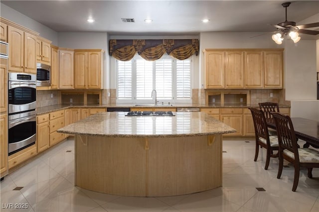 2041 Troon Dr, Henderson, NV 89074 - kitchen with light brown cabinets, stainless steel appliances, a kitchen island, and recessed lighting