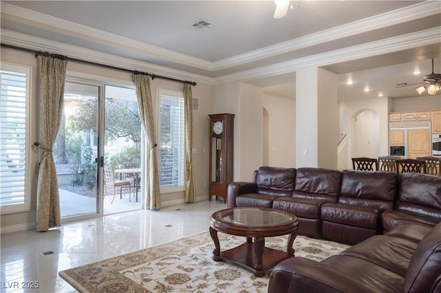 2041 Troon Dr, Henderson, NV 89074 - living room with arched walkways, ceiling fan, and crown molding