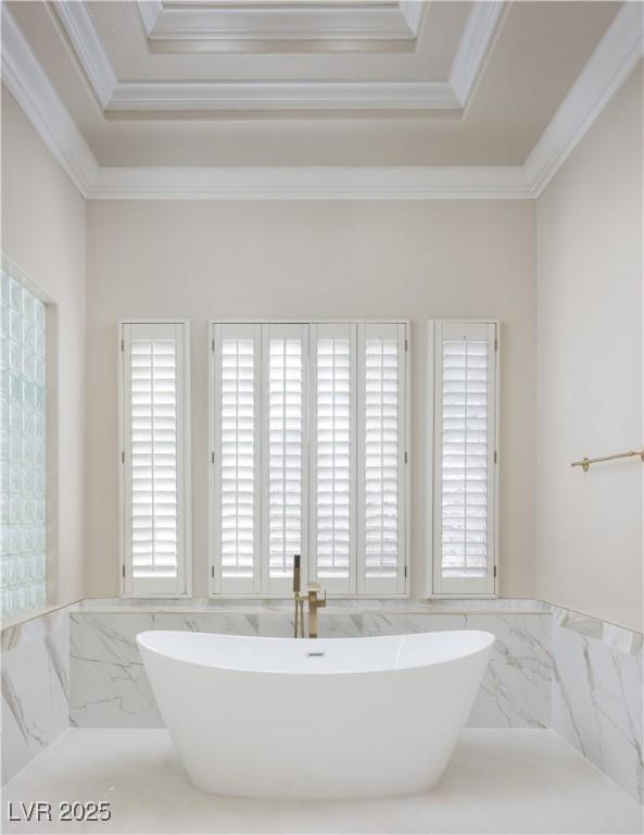2041 Troon Dr, Henderson, NV 89074 - full bath featuring crown molding, a freestanding bath, a raised ceiling, and tile walls